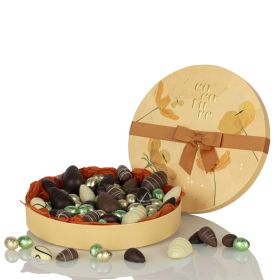 Marzipan eggs and chocolate eggs in a round Cocoture box
